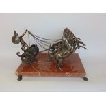 A bronzed figural group of a chariot scene with four horses and gladiator upon a red veined