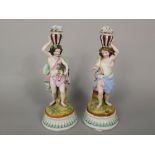 A pair of 19th century continental figures (probably adapted from candlesticks) each in the form