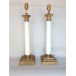 A pair Corinthian column table lamps with cast metal column tops and opaline glass stems upon