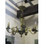 A heavy cast brass hanging ceiling light with pierced gothic trefoil fitting and moulded stem