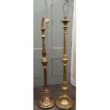 A near pair of gilded standard lamps with turned and fluted supports, raised on circular shaped