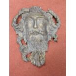 A 19th century carved timber green man with additional acanthus detail and later painted finish,