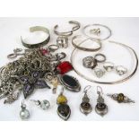 A collection of silver jewellery to include three bangles, two pairs of gem set drop earrings and