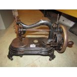 A vintage Bradbury cast iron hand operated sewing machine with worn gilt transfer detail