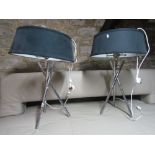 A stylish pair of chrome desk lamps upon three tubular tripod bases with black shades (2).