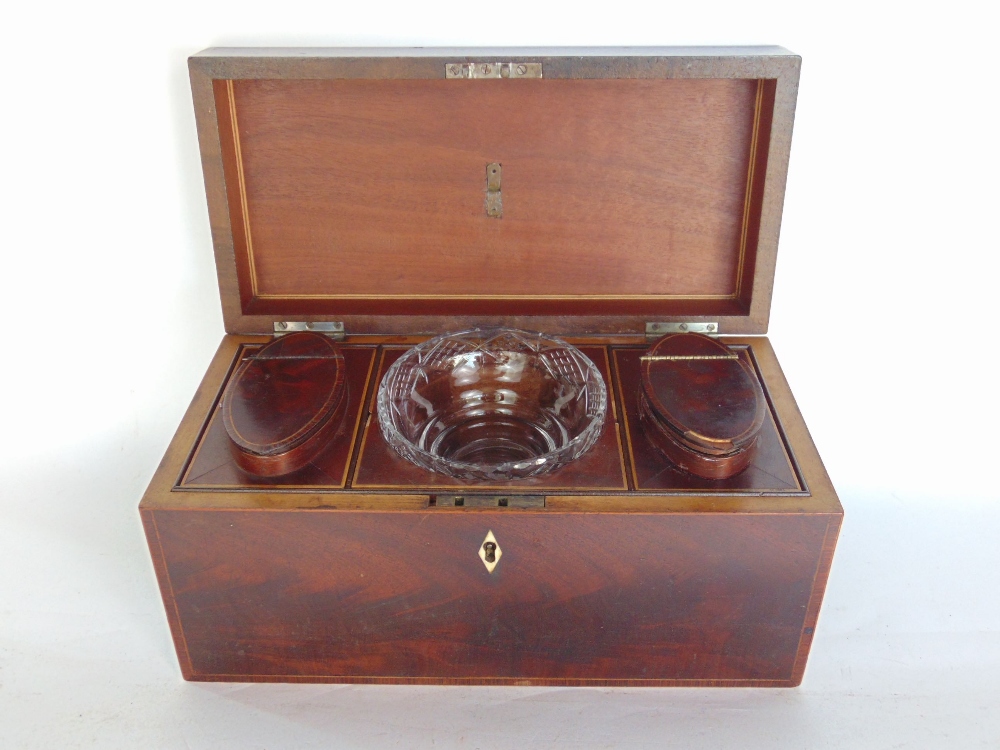 A 19th century flame mahogany tea caddy, the hinged lid enclosing a fitted interior to include two