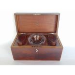 A 19th century flame mahogany tea caddy, the hinged lid enclosing a fitted interior to include two
