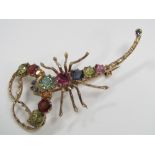 A gem set brooch in the form of a scorpion, marked 9ct, 9g