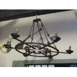 An iron work ceiling light of circular form with six fittings with arrow head and scrollwork