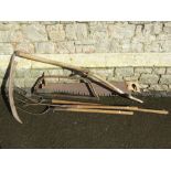 A vintage agricultural scythe with long ashwood handle together with two pitch forks, a saw and