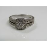 An 18ct white gold ring, central diamond 0.40cts approx, with tapered diamond set shoulders, size