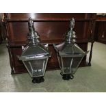 A pair of Victorian style street lantern hoods with polished frames