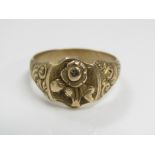 An 18ct gold ring engraved with scrolling decoration and embossed rose to centre, size S/T, 6g