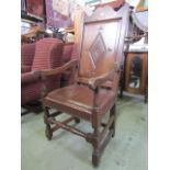 An Old English style oak wainscot type open armchair with fielded and carved lozenge shaped panelled