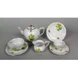 A collection of Herend tea for two wares with painted floral sprigs and sprays on a basket weave