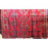 Turkish country house style carpet, decorated with various medallions upon a red ground, 360 x 280