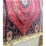 Good Persian rug, with geometric stars, birds and flower heads upon a red and blue ground with