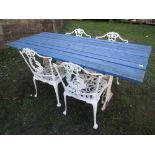 A garden table, the rectangular wooden blue painted slatted top raised on a pair of decorative