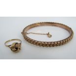 A 9ct hinged bangle of basket weave design, together with a 9ct interwoven knot type ring, size L/M,