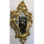 A shield shaped gilt framed wall mirror or pier glass, with C scroll and acanthus outline, 78 cm x