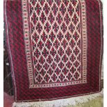 Persian thick weave wool carpet with geometric red and black pattern upon a cream ground, 180 x 10cm