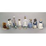 A collection of Nao figures including a girl wearing a wide brimmed hat and holding a chicken,