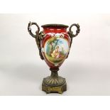 A 19th century continental red ground vase, with painted panels of Watteauesque style characters