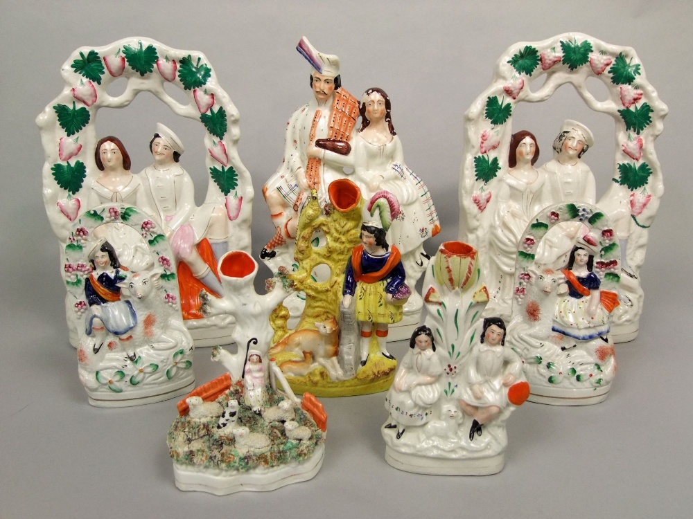 A collection of 19th century Staffordshire figures including a pair of arbour groups with a boy