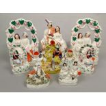 A collection of 19th century Staffordshire figures including a pair of arbour groups with a boy