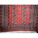 Turqoman rug decorated with recara type geometric medallions upon a burnt orange ground