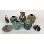 A collection of four oriental green glazed ginger jars with various relief moulded decoration, max