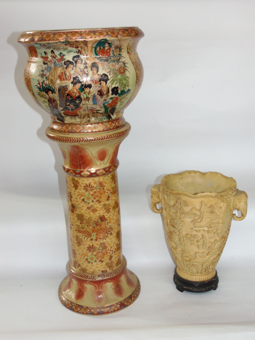 Japanese porcelain jardiniere on stand in the Satsuma manner, 70 cm high; together with a resin twin