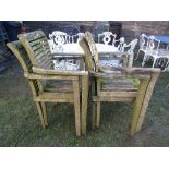 A set of four weathered contemporary teak garden armchairs with slatted seats and backs