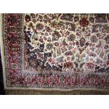 Persian silk Kashmir rug decorated with scrolled floral pattern upon an ivory ground, 240 x 140 cm