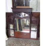 An Edwardian mahogany overmantle mirror, the panelled back incorporating six bevel edged plates of