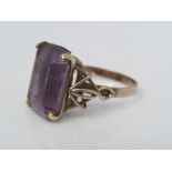 An amethyst ring in stylised yellow metal mount, size P, 4.5g