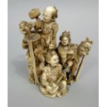 A good quality 19th century Japanese ivory Okimono, five figures - musician, singing, pouring drink,