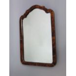 A 19th century tortoiseshell mirror with shaped and arched outline and easel back, 35 cm max