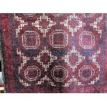 Old Baluchi rug with geometric medallions upon a navy blue ground