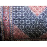 Good Persian wool carpet with geometric sky blue pattern around a central orange medallion upon a