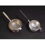 Two silver strainer spoons together with two associated bowls (4)