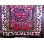 Good Persian Heriz runner with various red and cream medallions upon an ochre ground, 330 x 120cm