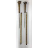 Pair of Chinese embossed brass sword sticks, each mounted by a dragon head knop with scrolled