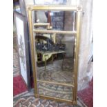 A gilt framed chimney glass with triple bevelled edge mirror plates, within a gilt moulded frame