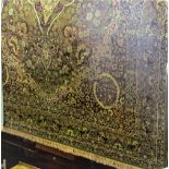 Persian wool carpet decorated with various scrolled yellow and red foliage upon a green ground,