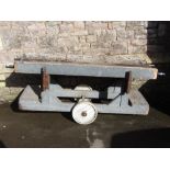 A vintage industrial work trolley with light blue painted wooden frame and rectangular dished top