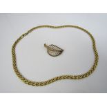 A 9ct necklace of plaited design, together with a 9ct openwork leaf brooch, 14g total