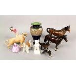 A collection of Beswick animals including a prowling lioness, two brown glazed horses and a brown