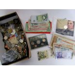 A collection of mixed unsorted English and worldwide coinage and bank notes