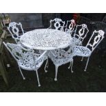 A cast aluminium garden terrace table with decorative pierced and scrolling foliate circular top